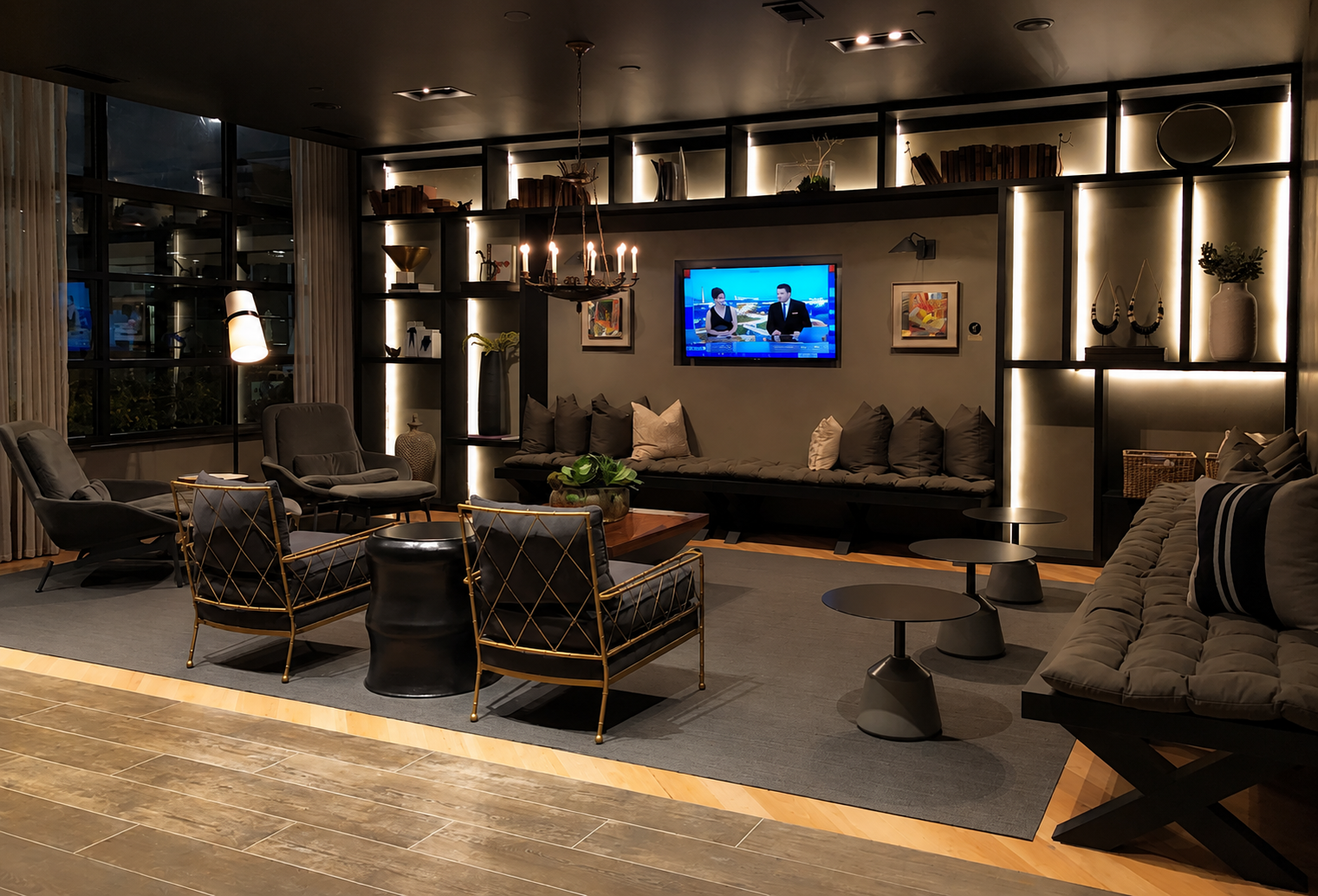 Modern lounge room with dark wood flooring, gray rug, and stylish furniture.