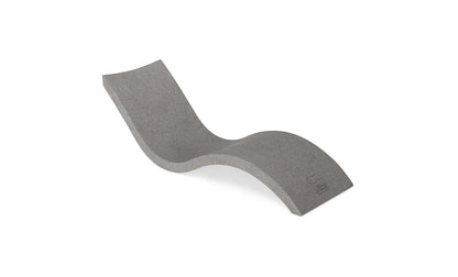 Curved sandstone chaise lounge with a smooth, wave-like shape on a plain white background.
