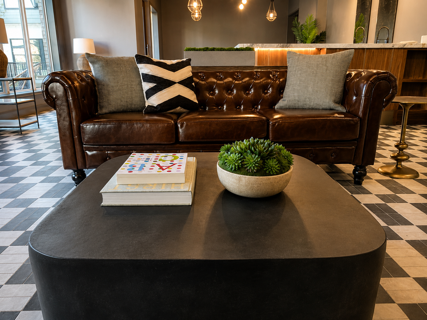 Brown leather sofa with decorative pillows in a living room setting.