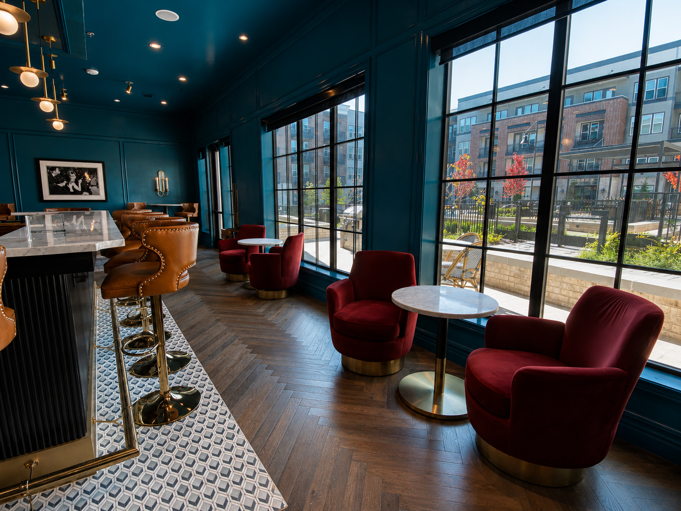 Modern bar interior with red chairs and large windows