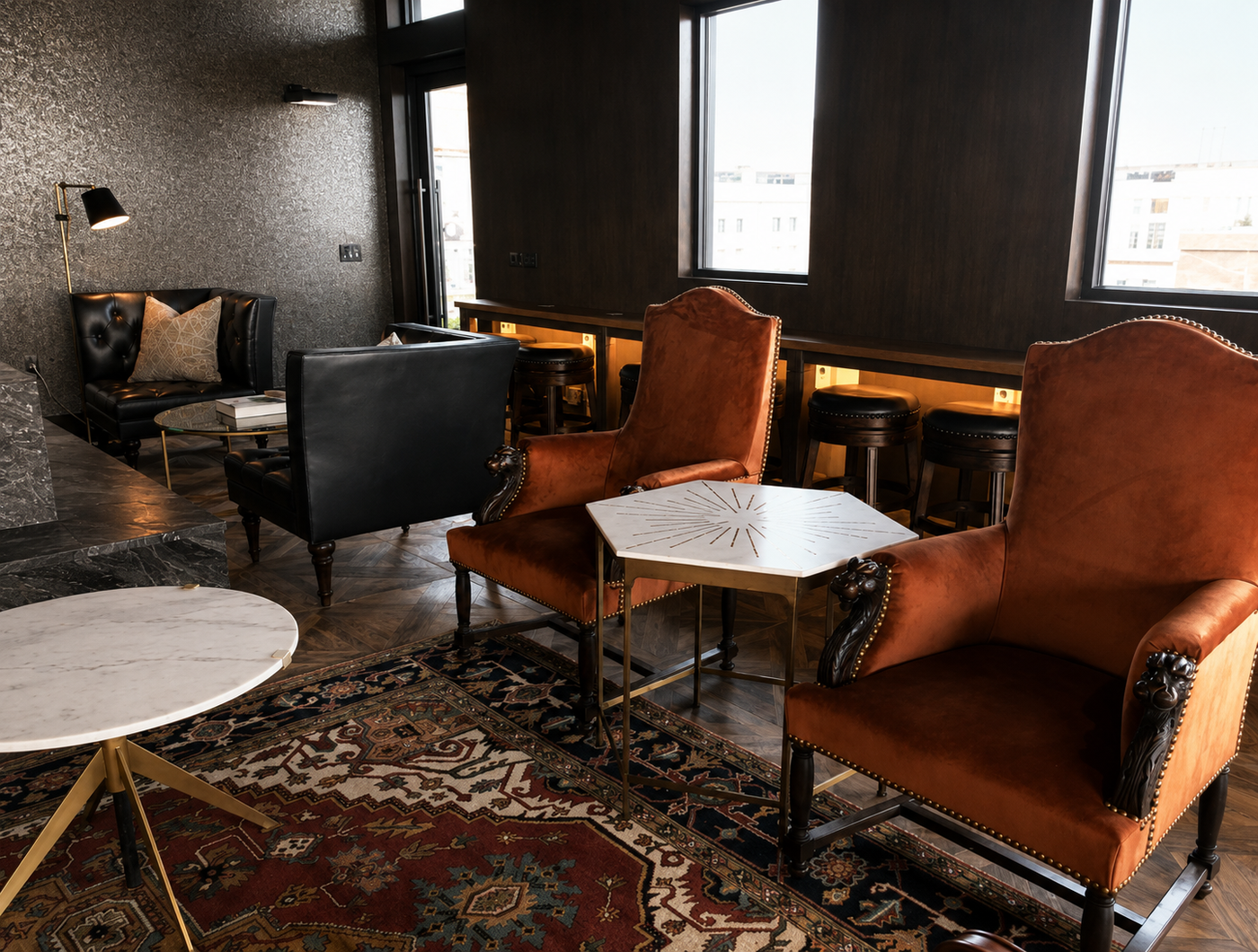 Luxury lounge with leather chairs, a coffee table, and decorative elements.