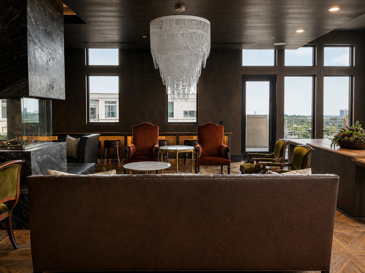 Modern interior with a chandelier, couch, and chairs in a well-lit room.