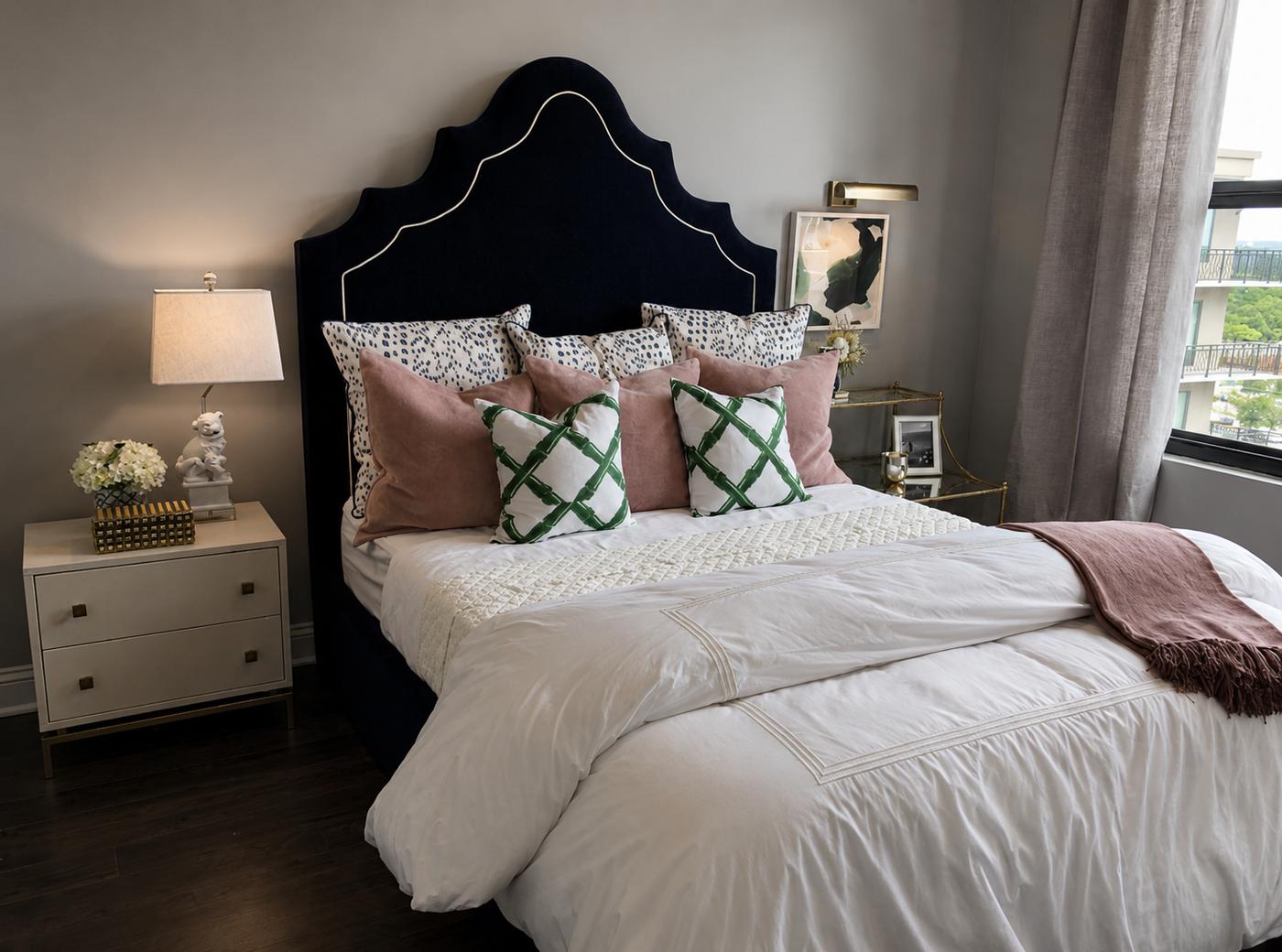 Neatly made bed with decorative pillows in a bedroom setting.