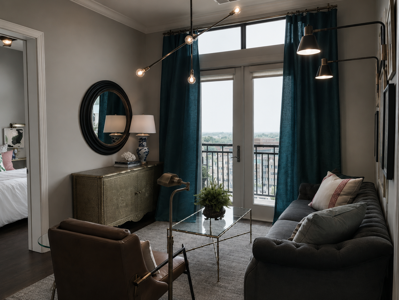 Modern living room with a sofa, chair, coffee table, and large windows with blue curtains.