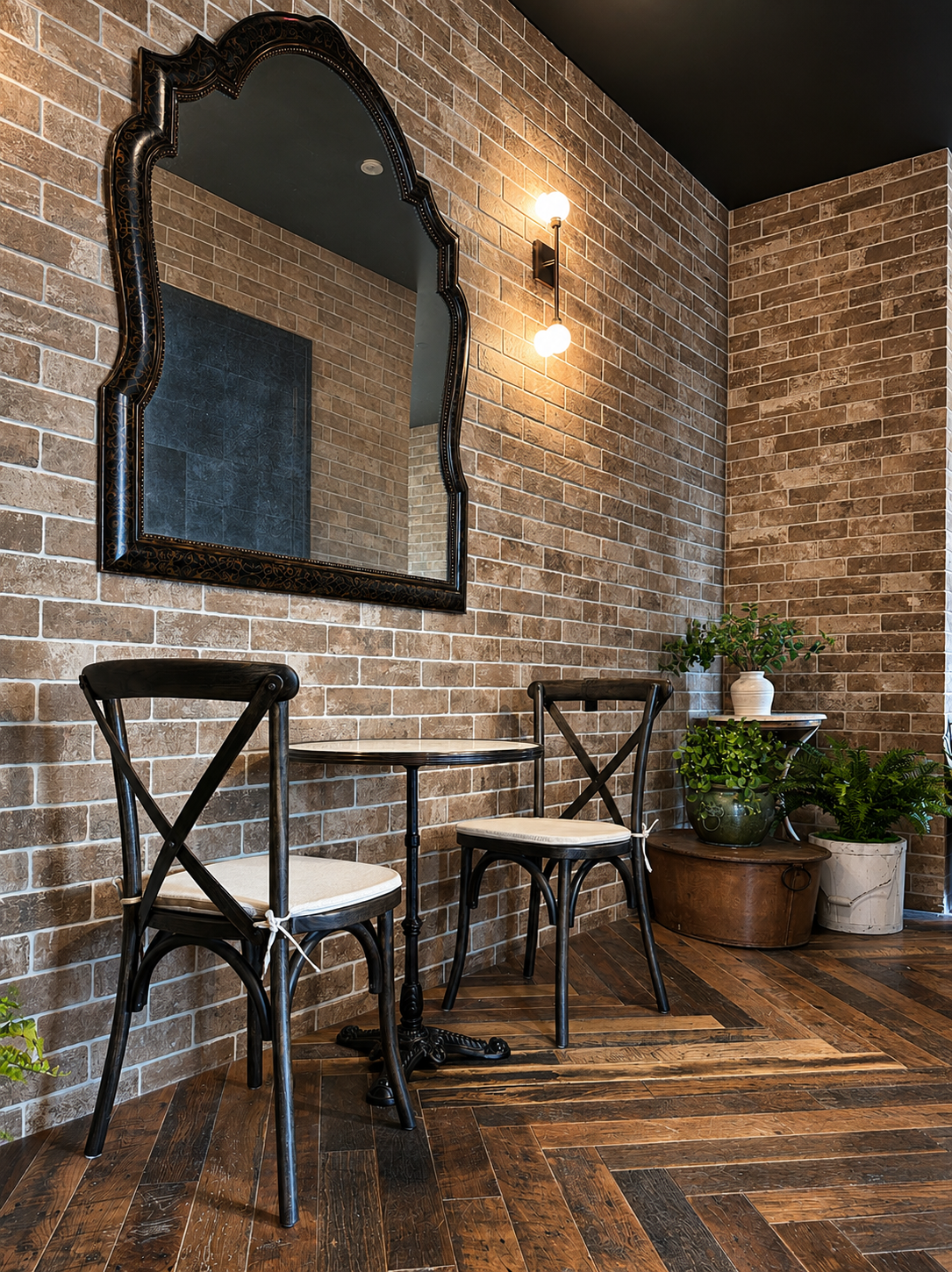 Bistro setting with brick walls, wooden floor, and black metal chairs.