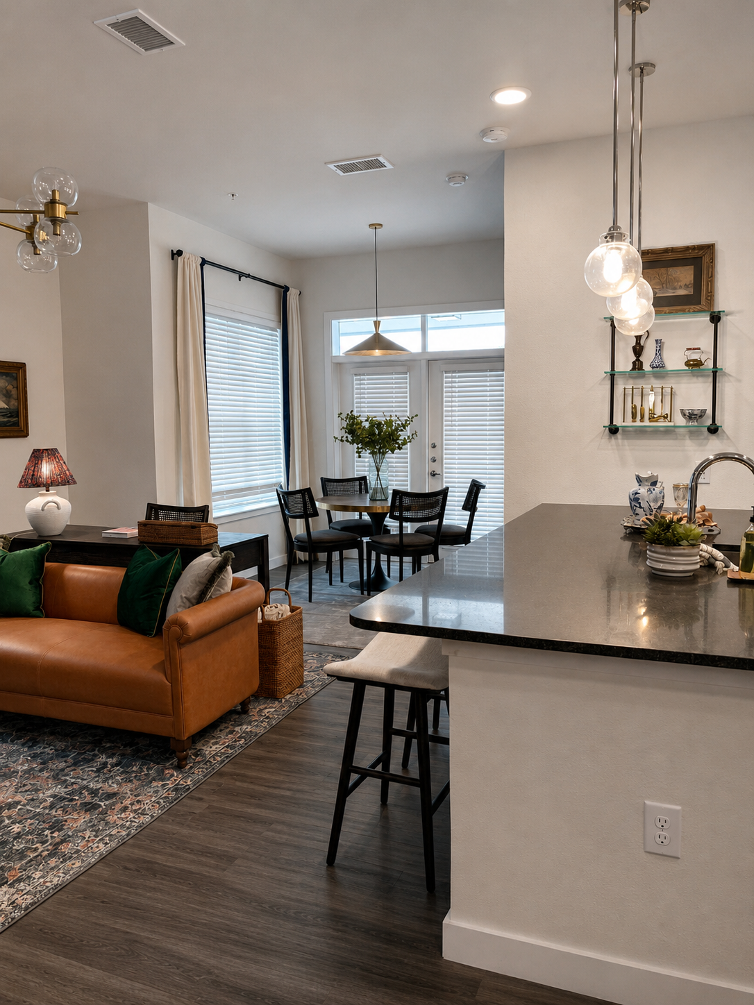 Modern living room with brown sofa, kitchen island, and dining area.