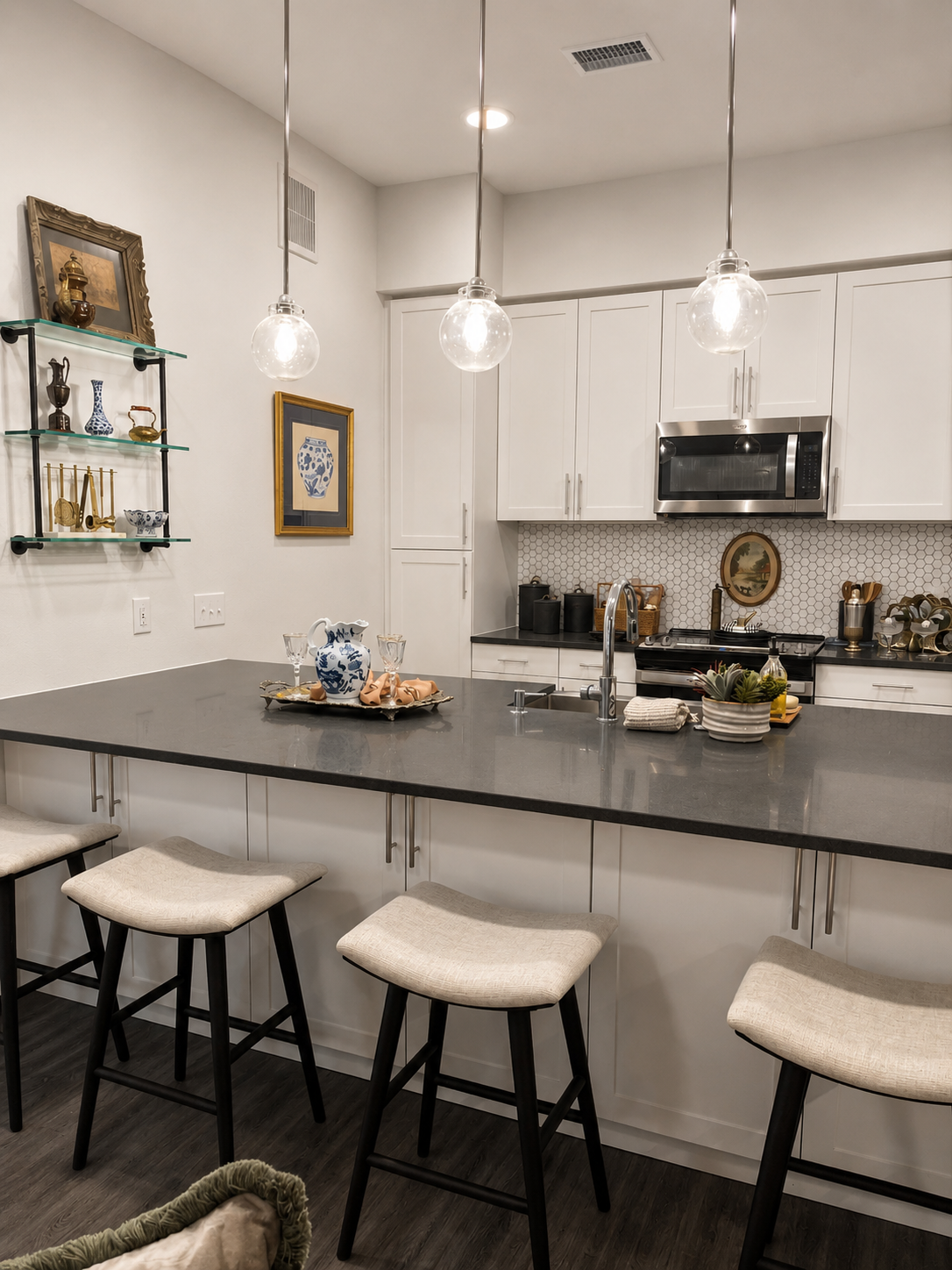 Modern kitchen with a island, stools, and various appliances.