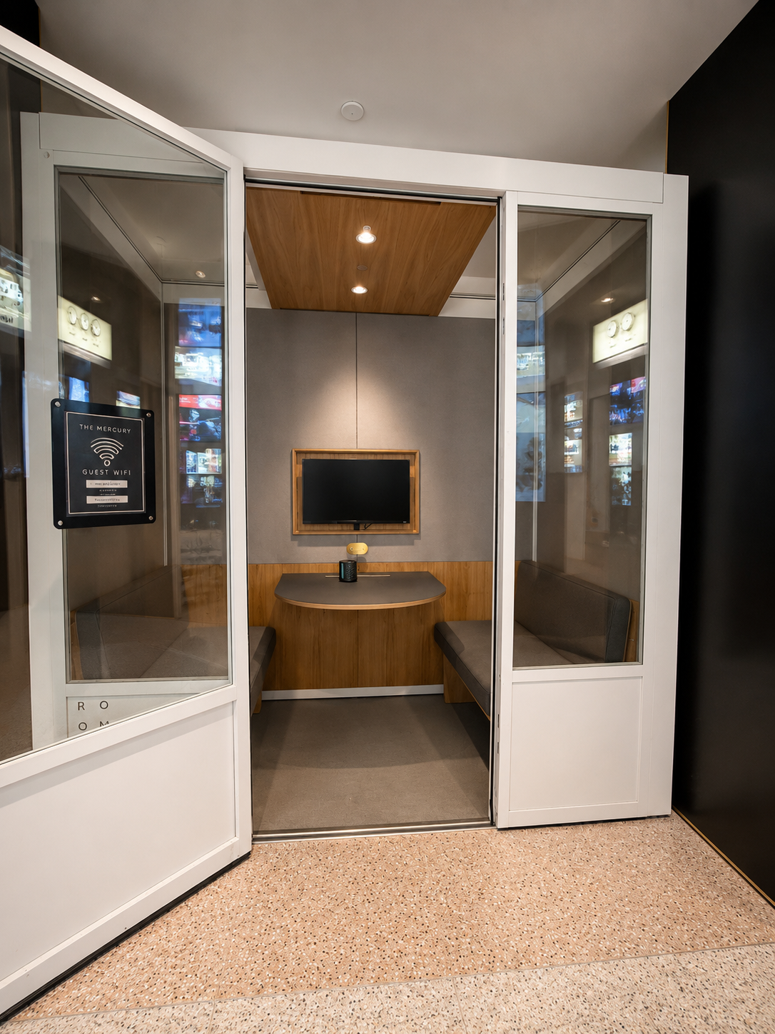 Modern office cubicle with glass walls and wooden interior