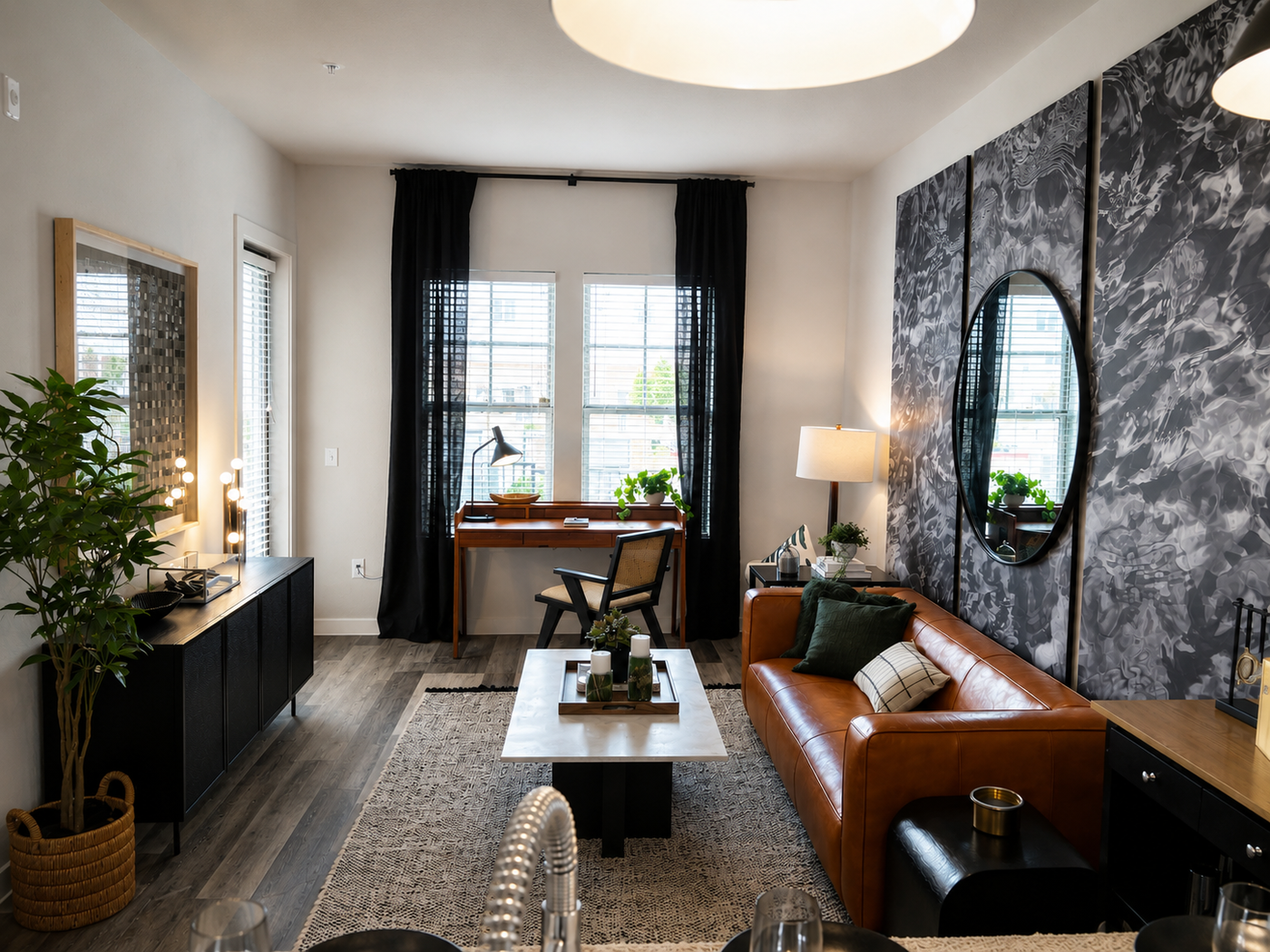 Modern living room with a brown leather sofa, coffee table, and decorative elements.