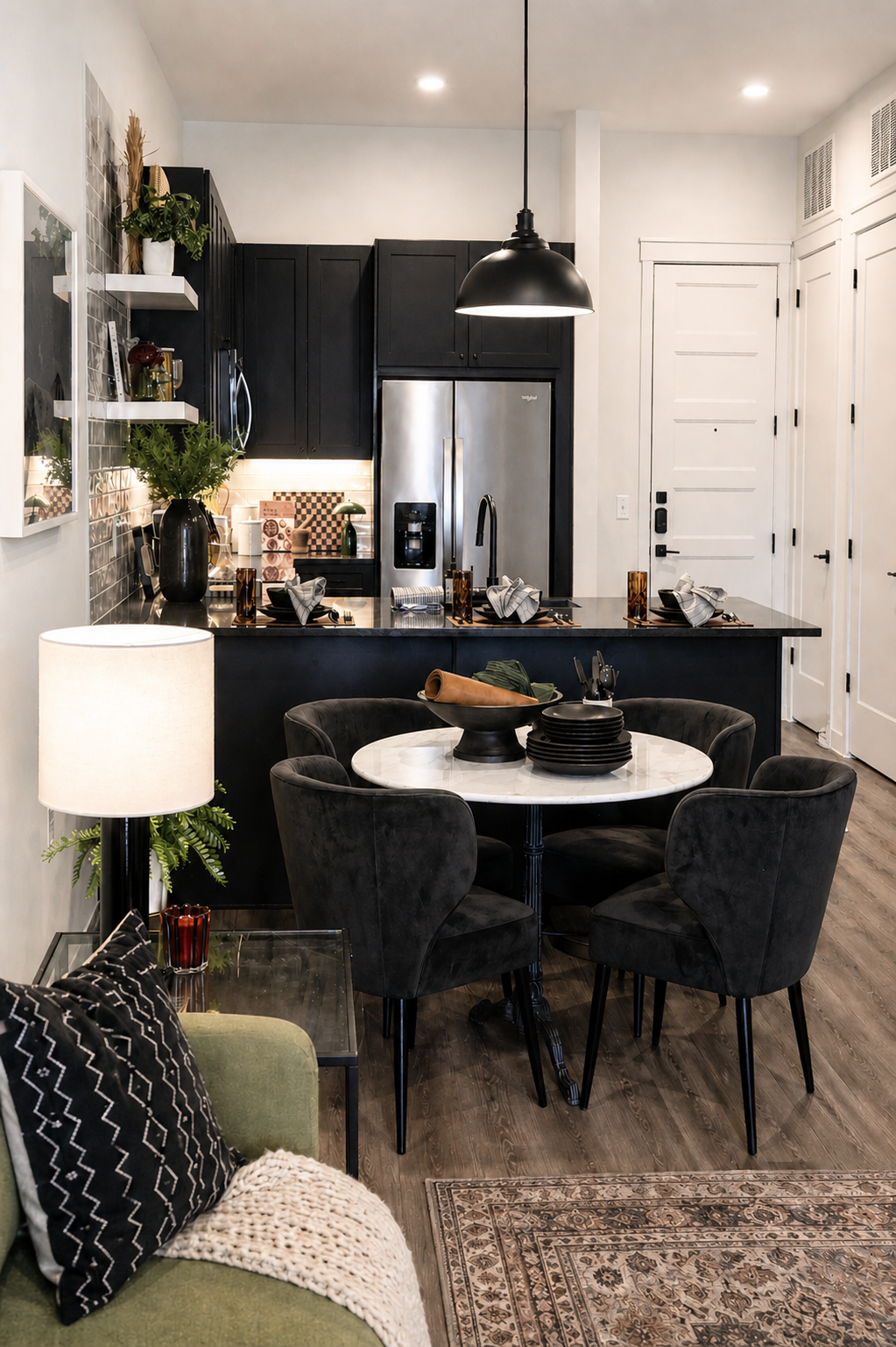 Modern kitchen with black island, gray chairs, and decorative elements.