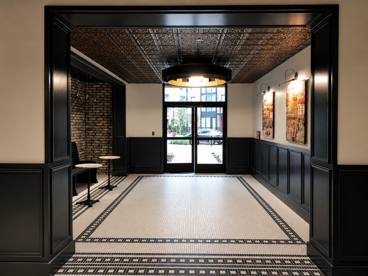 Foyer with black wainscoting, patterned floor, and large mirror.