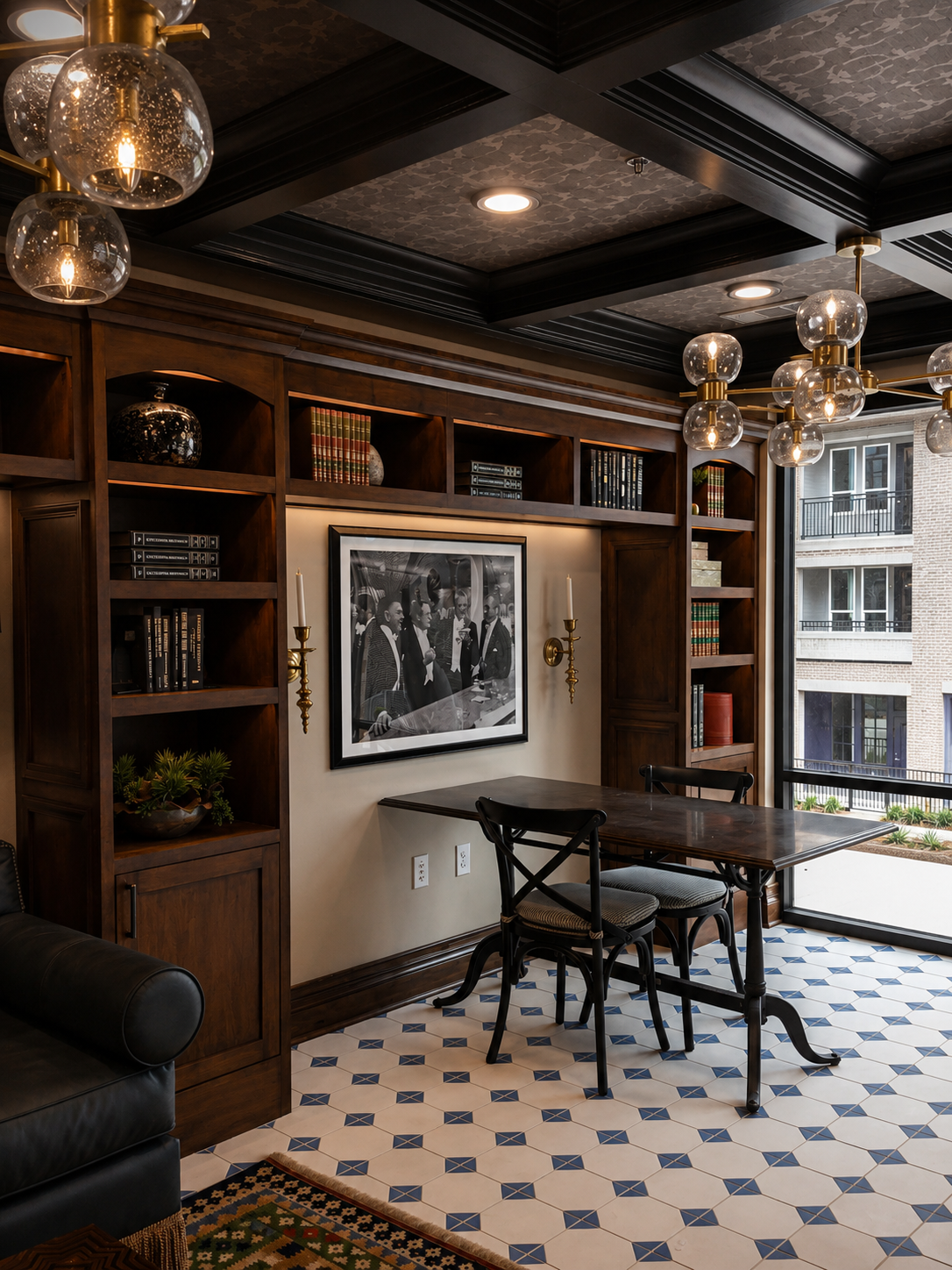 Luxurious room with wooden bookshelves, framed picture, and a table with chairs.