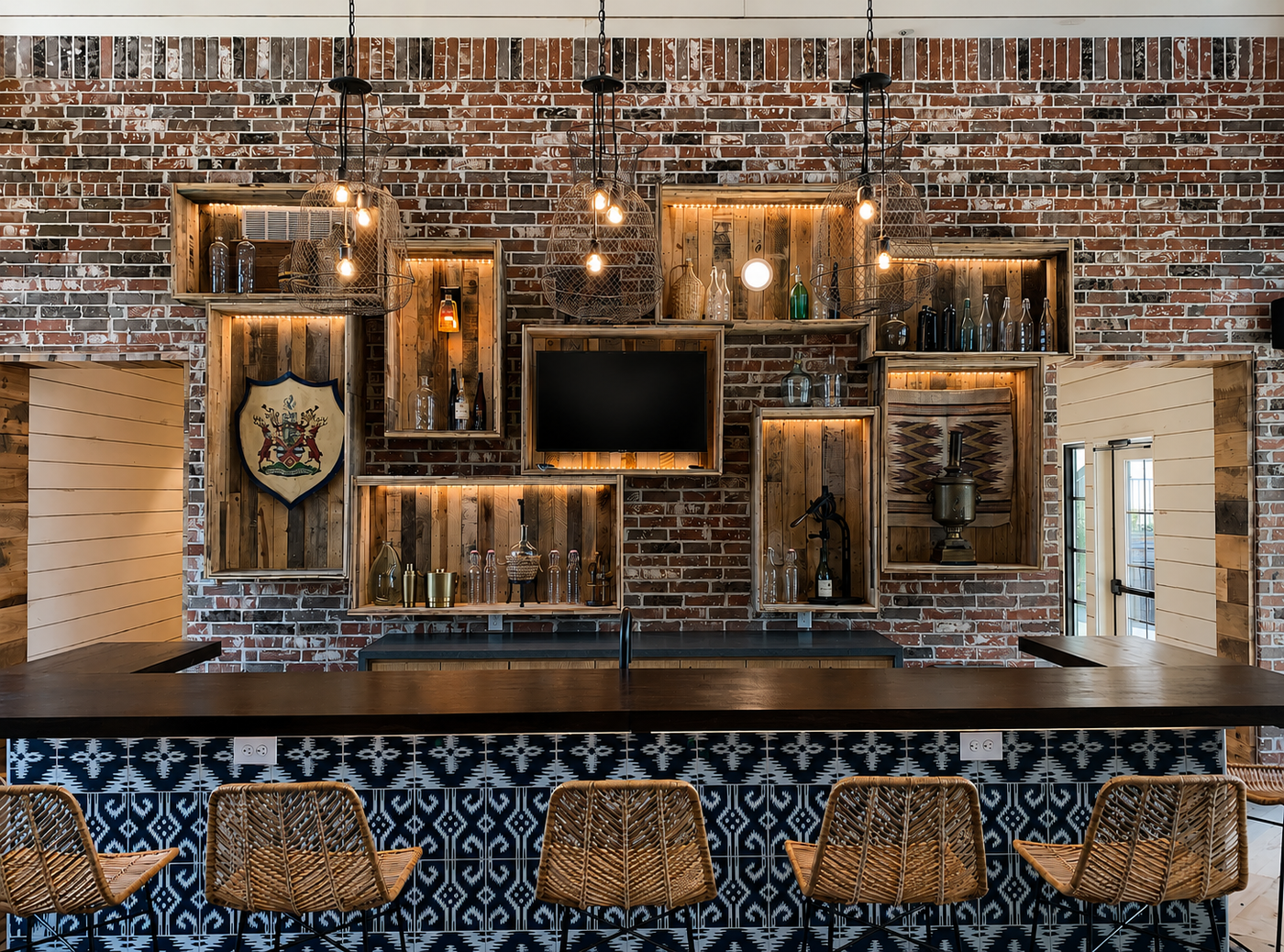Bar area with brick wall, wooden shelves, and a television.