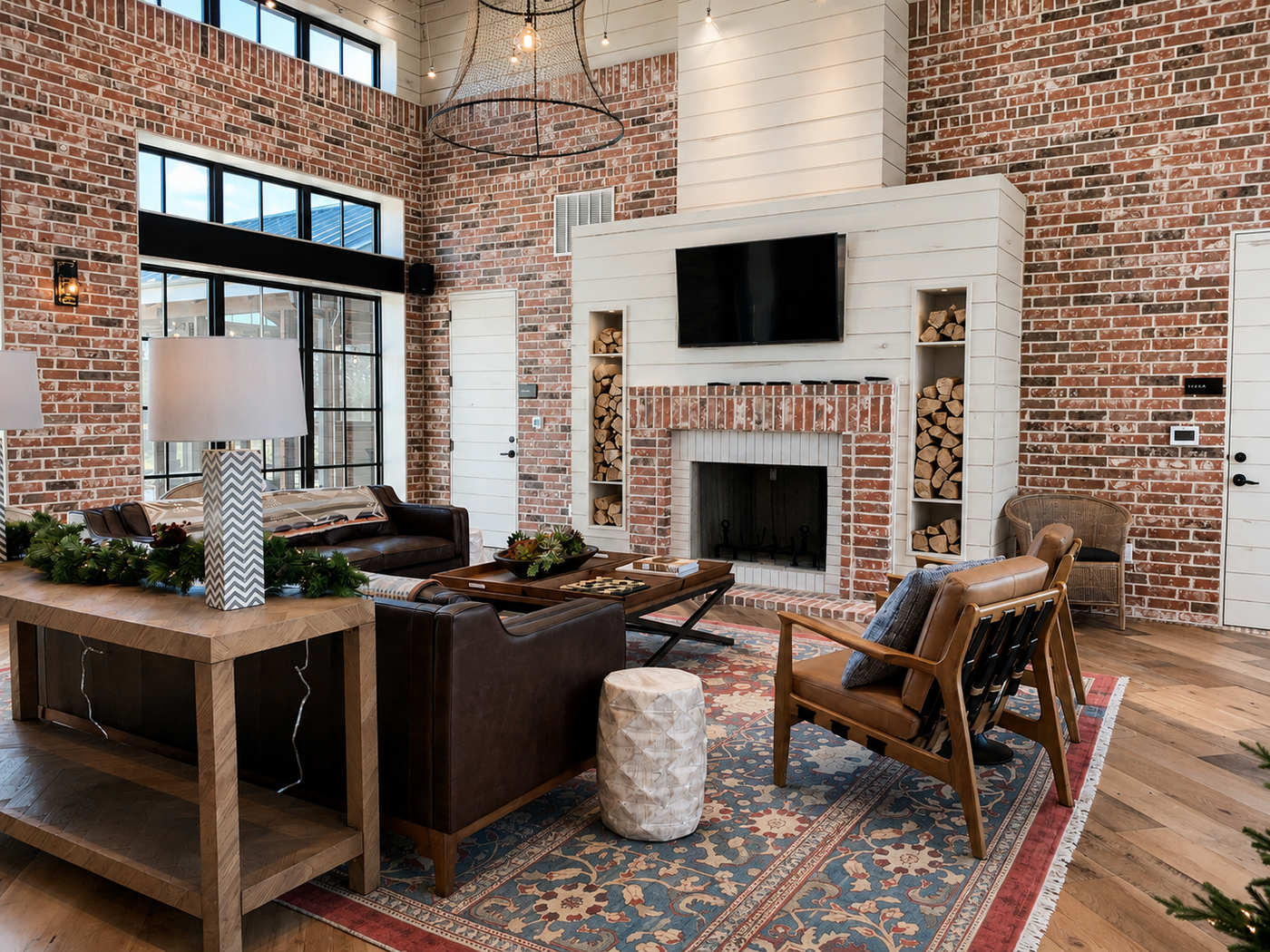club area with brick walls, a fireplace, and modern decor.