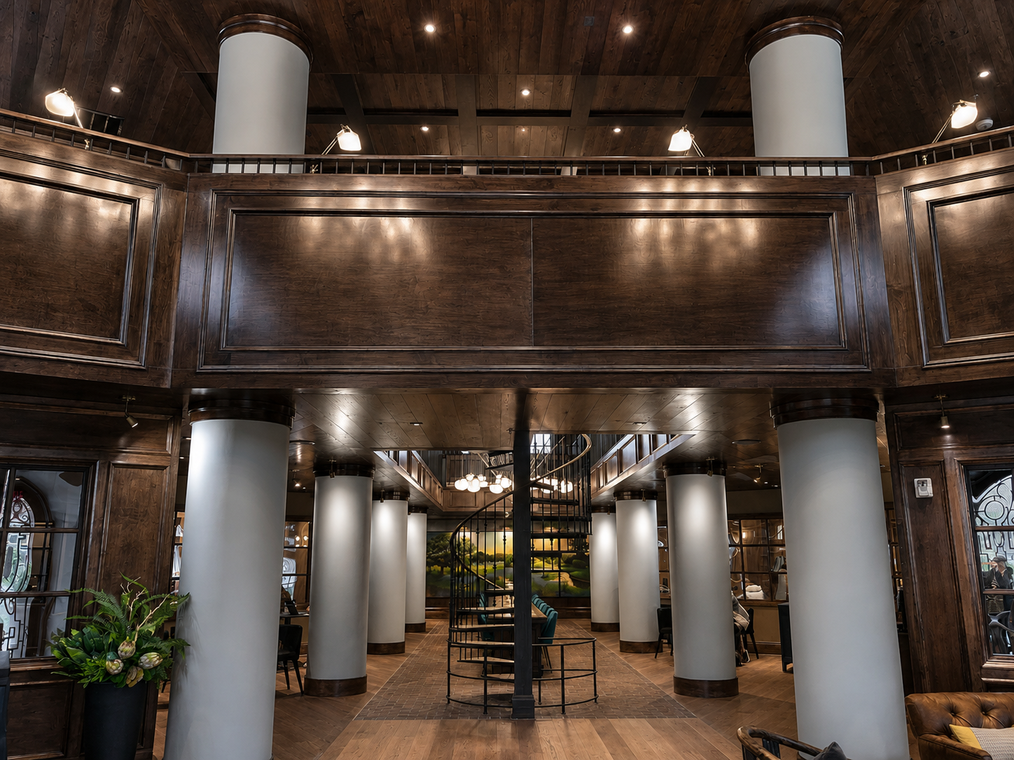 Grand interior with wooden beams, columns, and a high ceiling.